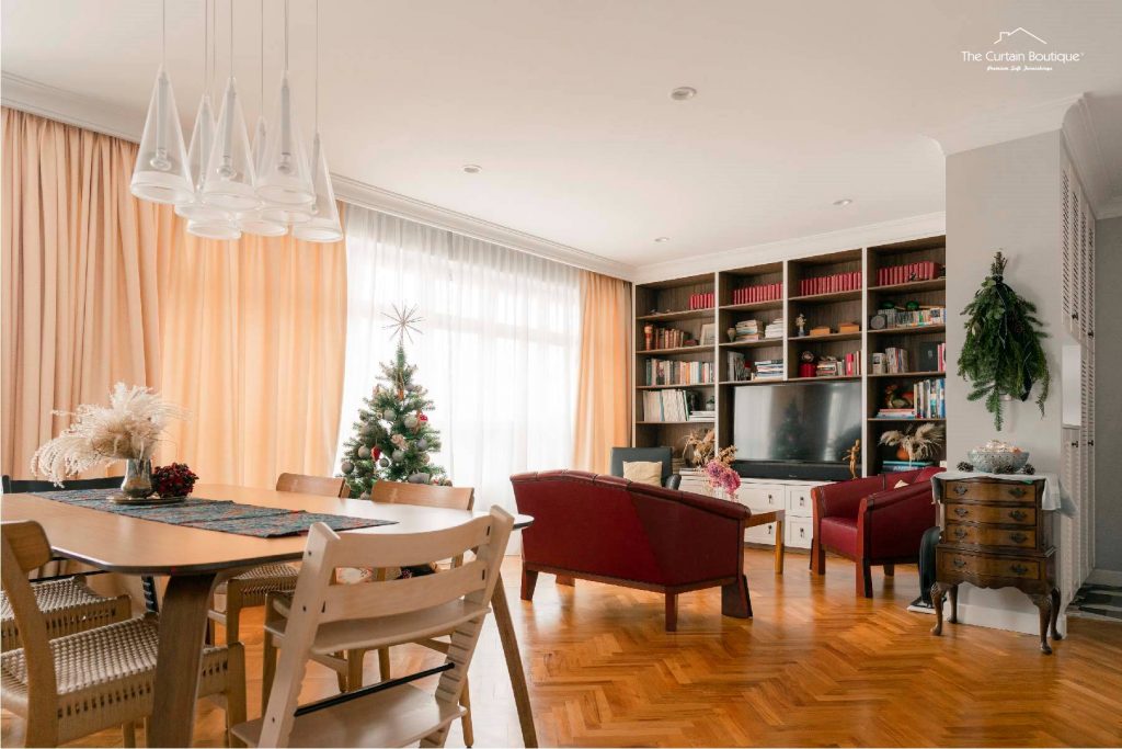 Mustard curtains in a cosy Singapore property dining and living room with sheer drapes and built-in bookshelf.