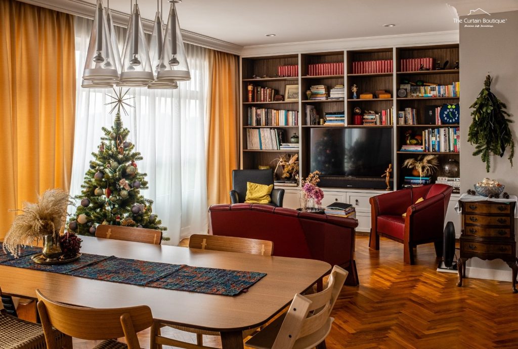 Mustard curtains in a cosy Singapore property dining and living room with sheer drapes and built-in bookshelf.
