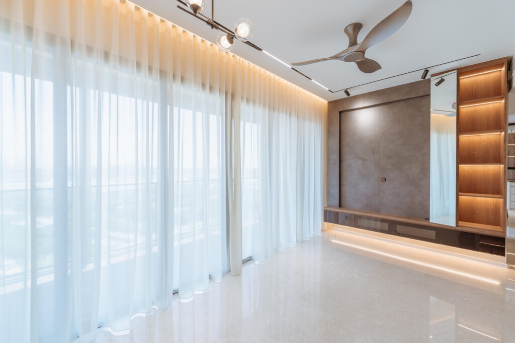 Beautiful sheer day curtains in a long living room sliding door