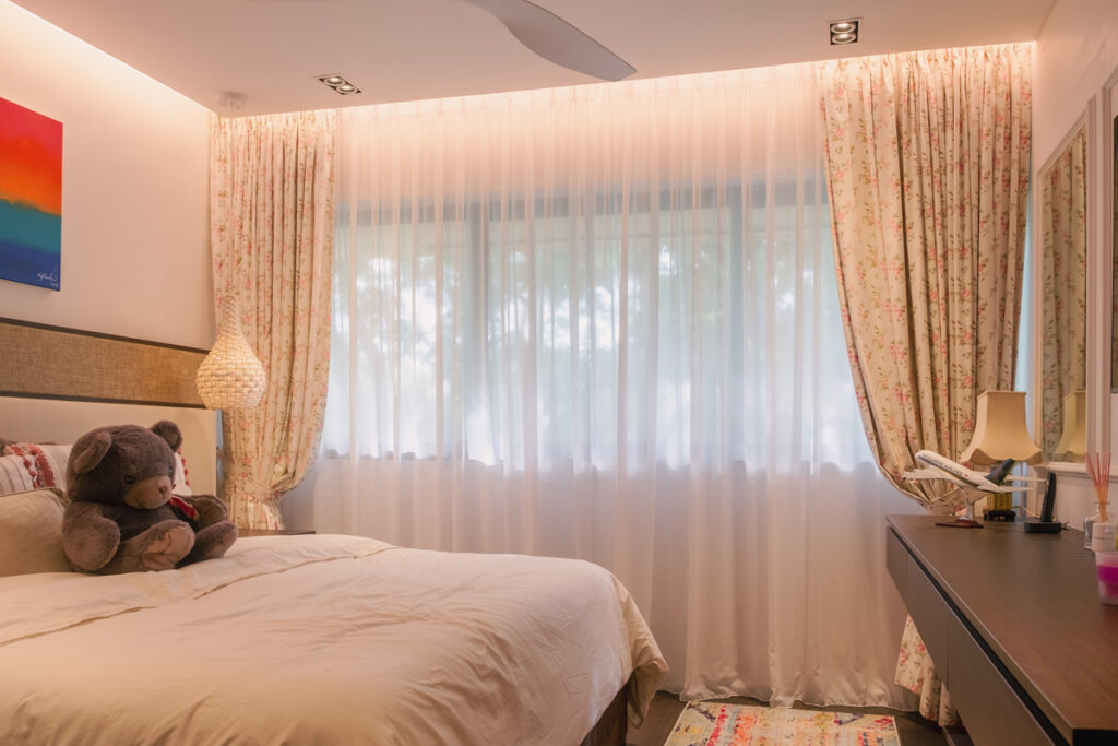 Floral patterned day sheer curtains with printed dim out curtains in a singapore bedroom