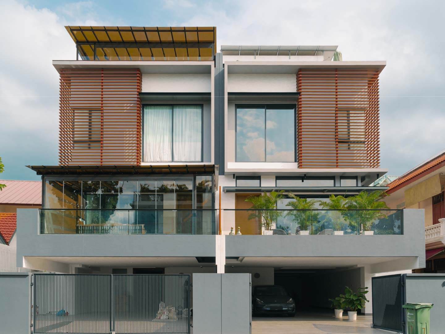 semi detached landed property with clear glass curtains and tinted polycarbonate roofing compared to neighbour without shelter on terrace