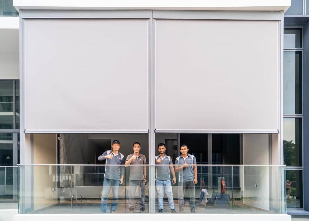 The Curtain Boutique installers in front of the Ziptrak at a condo balcony in Singapore