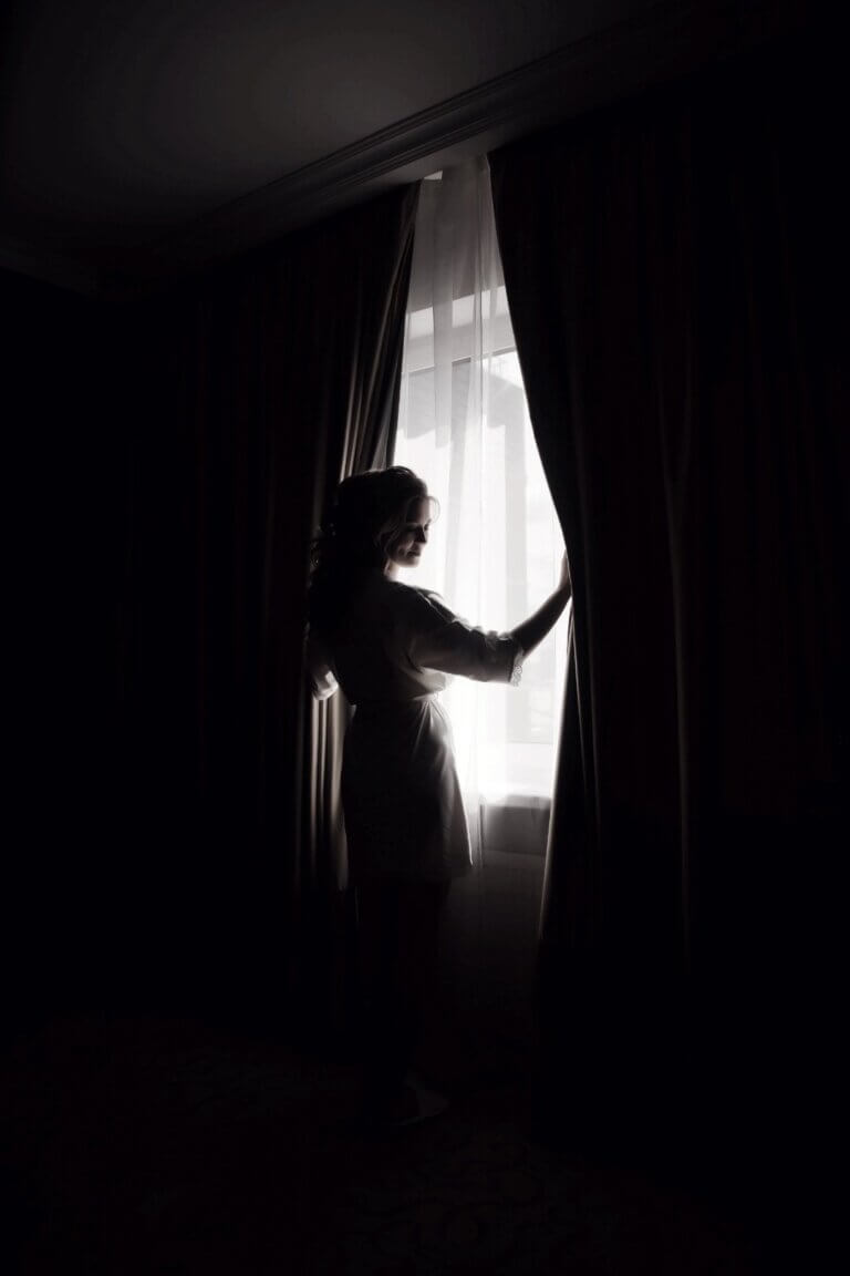 Blackout curtains in a Singapore bedroom being slightly opened to let some morning light in after rest
