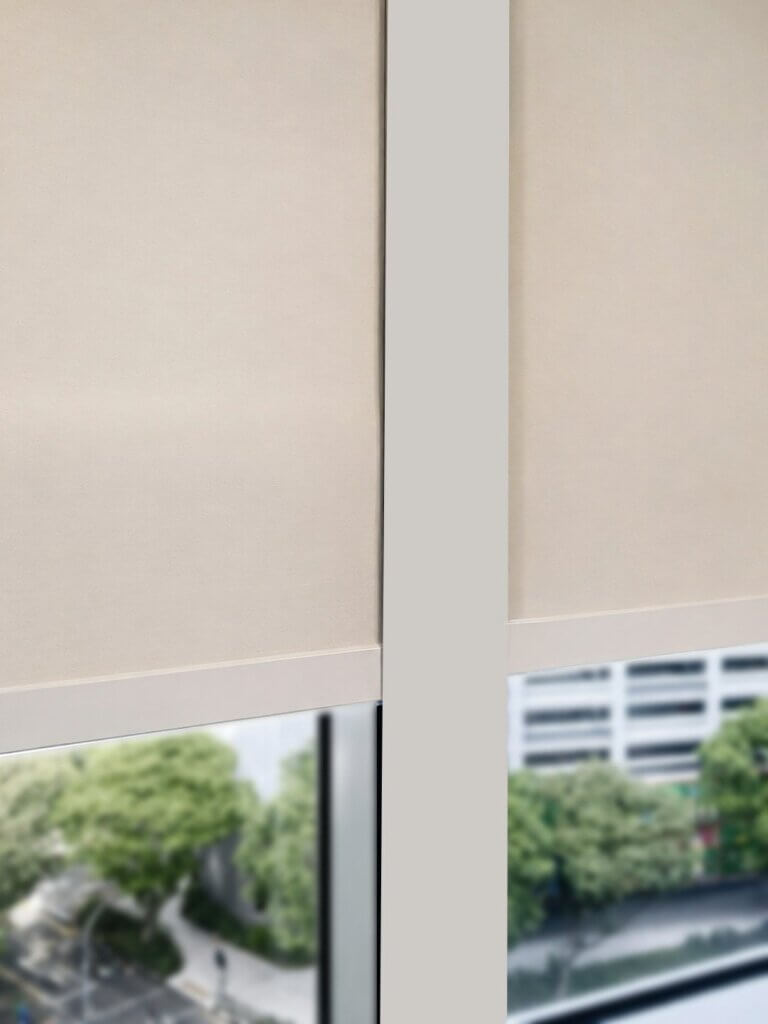 Roller blinds with U-channels installed in a Singapore bedroom to improve side coverage and reduce light gaps